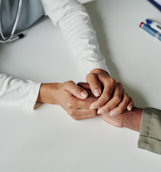 doctor holding patients hand